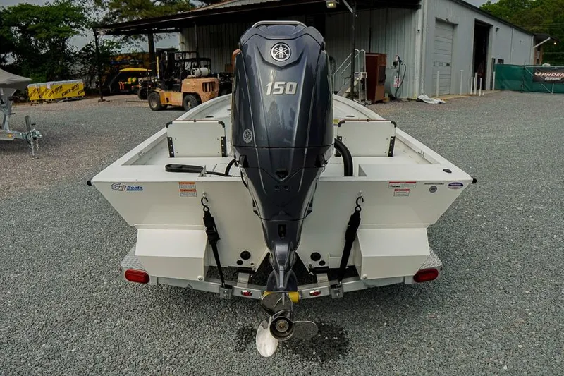 Slide: The Image of 2026 G3 Bay 21 GX Tunnel boat with Yamaha 150 outboard motor, parked on gravel. - 4