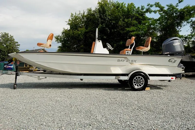 Slide: The Image of 2026 G3 Bay 21 GX Tunnel boat on trailer, parked outdoors. - 8