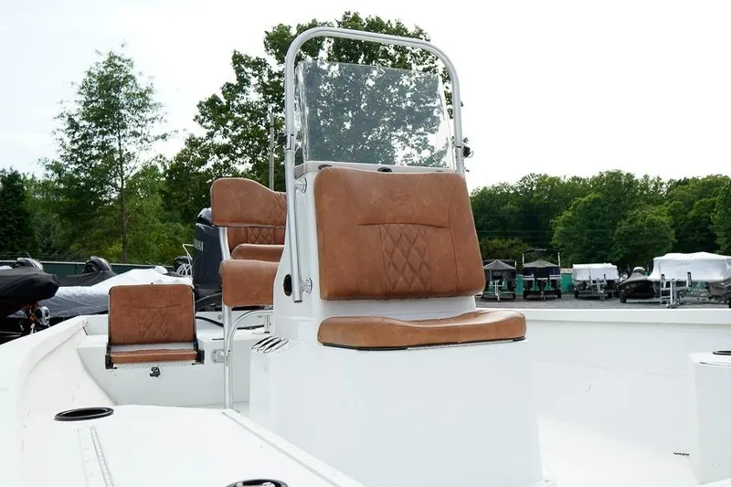 Slide: The Image of 2026 G3 Bay 21 GX Tunnel boat with brown cushioned seats and console. - 9