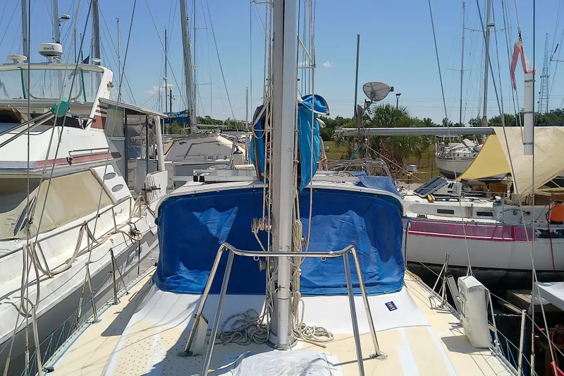 Slide: The Image of 1972 Morgan Out Island 41 sailboat docked among other vessels in a marina. - 13