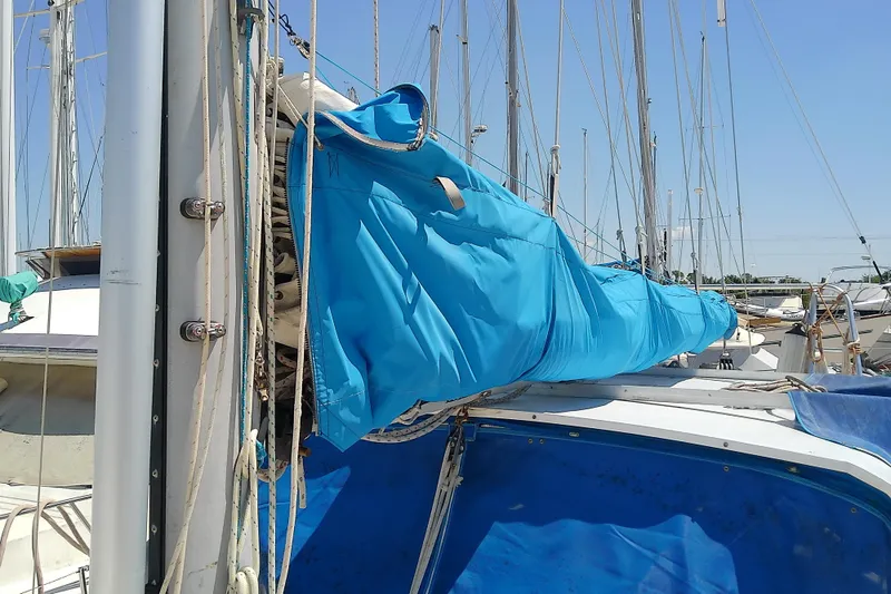 Slide: The Image of 1972 Morgan Out Island 41 sailboat with blue sail cover in marina. - 14