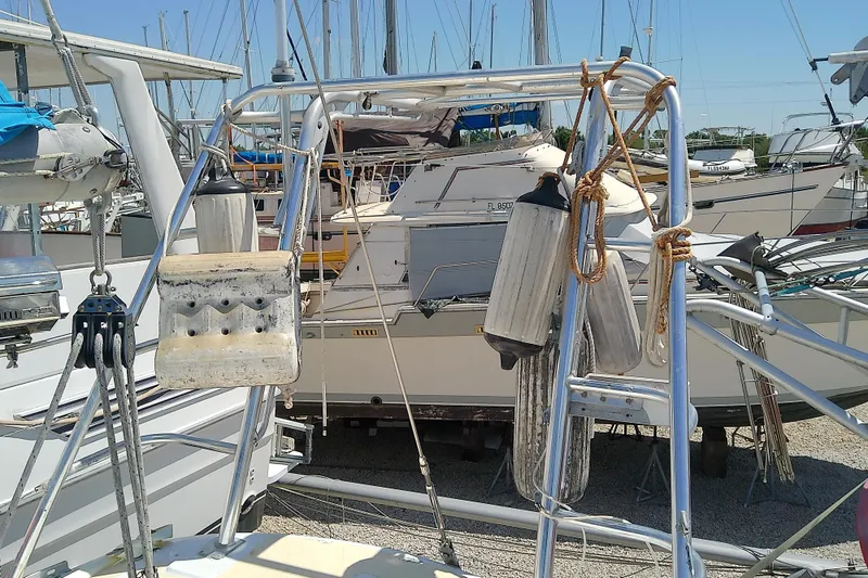 Slide: The Image of 1972 Morgan Out Island 41 sailboat in a marina, surrounded by nautical equipment and other boats. - 15