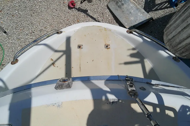 Slide: The Image of Bow of 1972 Morgan Out Island 41 sailboat on gravel, showing deck fittings and railings. - 18