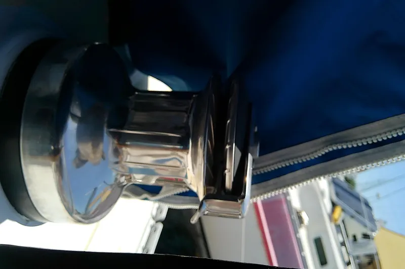 Slide: The Image of Close-up of a winch on a 1972 Morgan Out Island 41 sailboat, with blue canvas cover. - 19