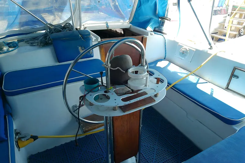 Slide: The Image of 1972 Morgan Out Island 41 sailboat cockpit with blue seating and steering wheel. - 21