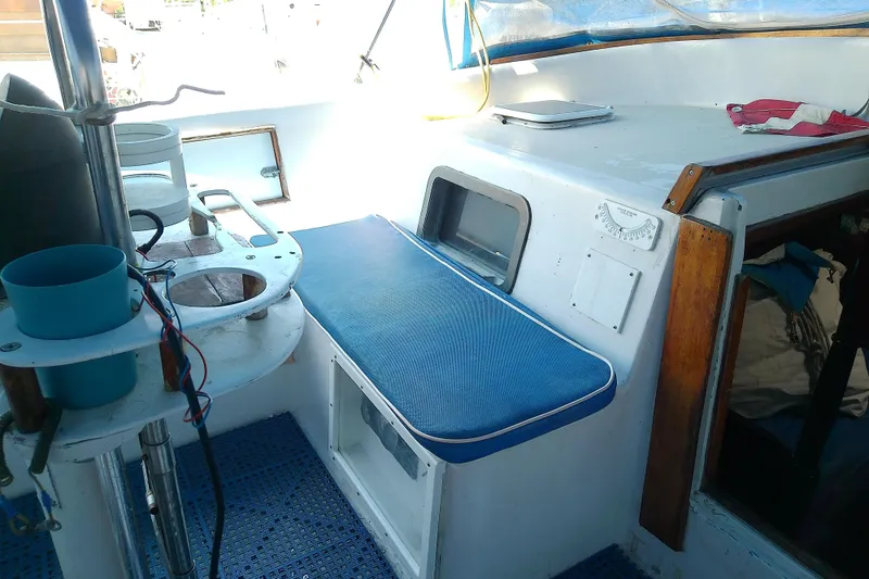 Slide: The Image of 1972 Morgan Out Island 41 sailboat cockpit with blue seating and nautical equipment. - 22