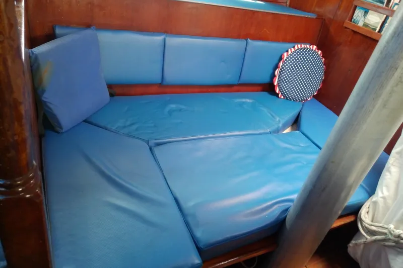 Slide: The Image of Interior of 1972 Morgan Out Island 41 sailboat with blue cushioned seating. - 26