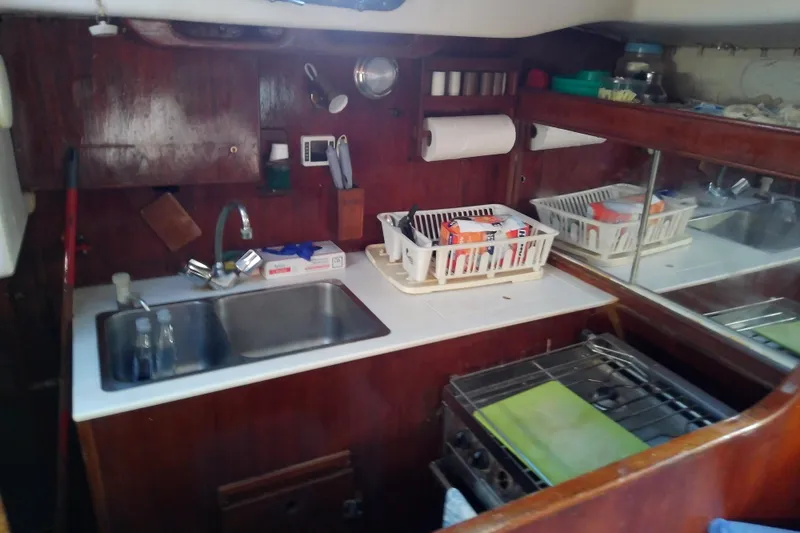 Slide: The Image of 1972 Morgan Out Island 41 yacht kitchen with sink, stove, and storage. - 28