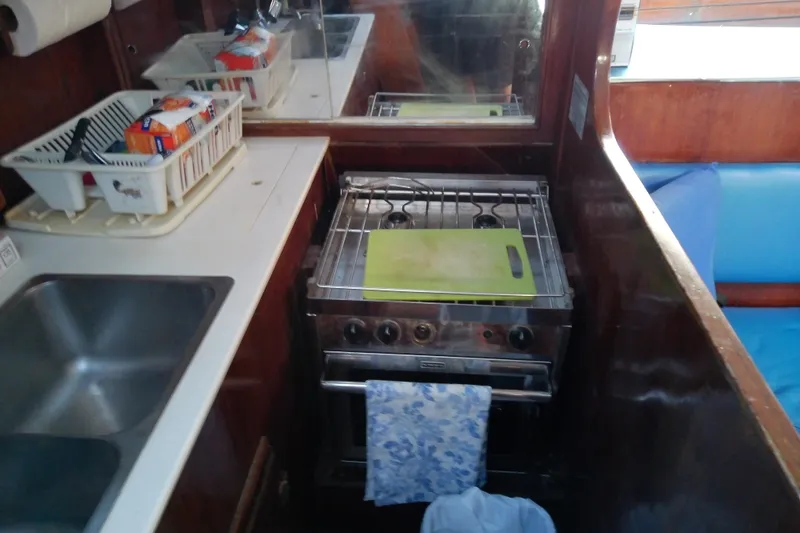 Slide: The Image of 1972 Morgan Out Island 41 yacht kitchen with stove, sink, and countertop essentials. - 29
