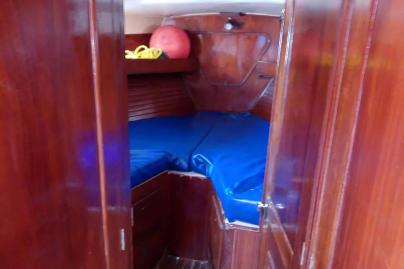 Slide: The Image of Interior cabin of 1972 Morgan Out Island 41 sailboat with blue cushions. - 32