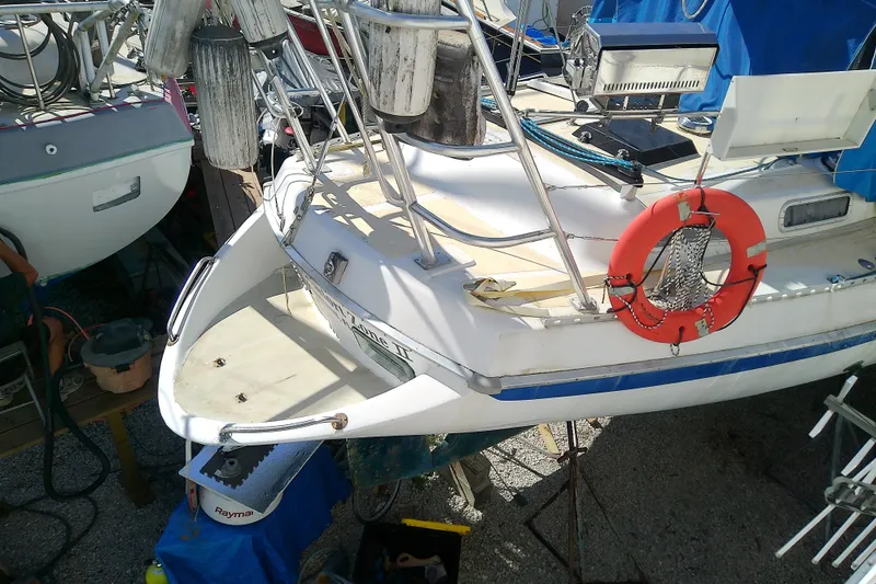 Slide: The Image of 1972 Morgan Out Island 41 sailboat with lifebuoy and deck equipment in a marina. - 13