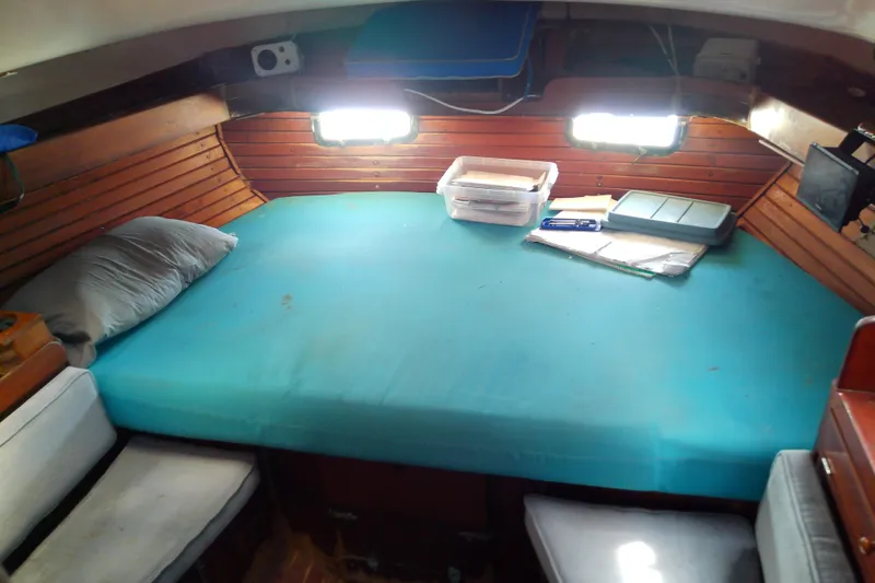 Slide: The Image of Cozy cabin interior of 1972 Morgan Out Island 41 sailboat with teal bedding. - 41