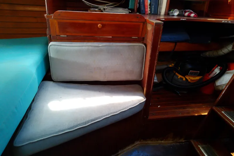 Slide: The Image of Interior of a 1972 Morgan Out Island 41 sailboat with cushions and storage. - 43