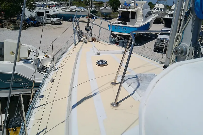 Slide: The Image of 1972 Morgan Out Island 41 sailboat on dry dock, surrounded by other boats. - 8