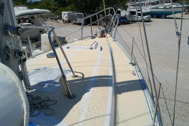 Slide: The Image of 1972 Morgan Out Island 41 sailboat deck, docked in a marina, with visible rigging and equipment. - 9