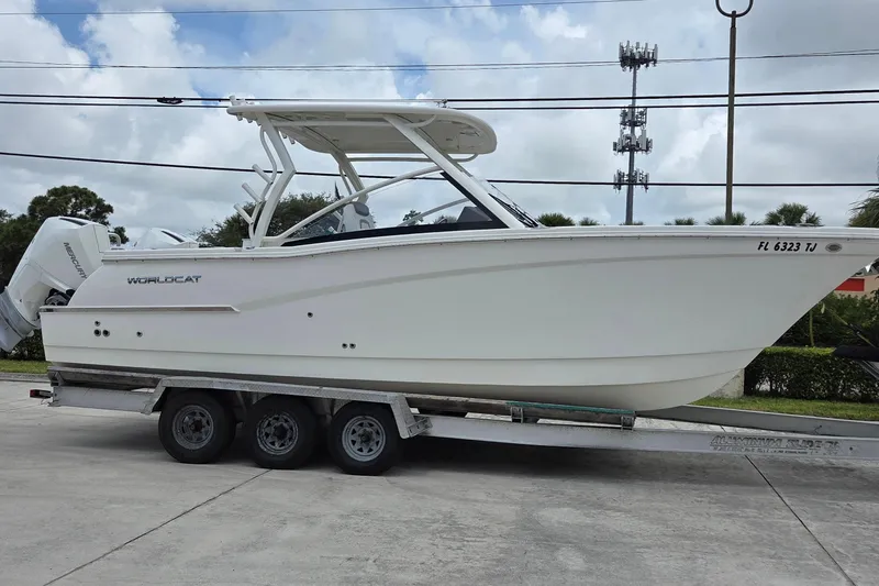 The Image of 2023 World Cat 280 DC-X boat on trailer, side view, outdoors. - 0