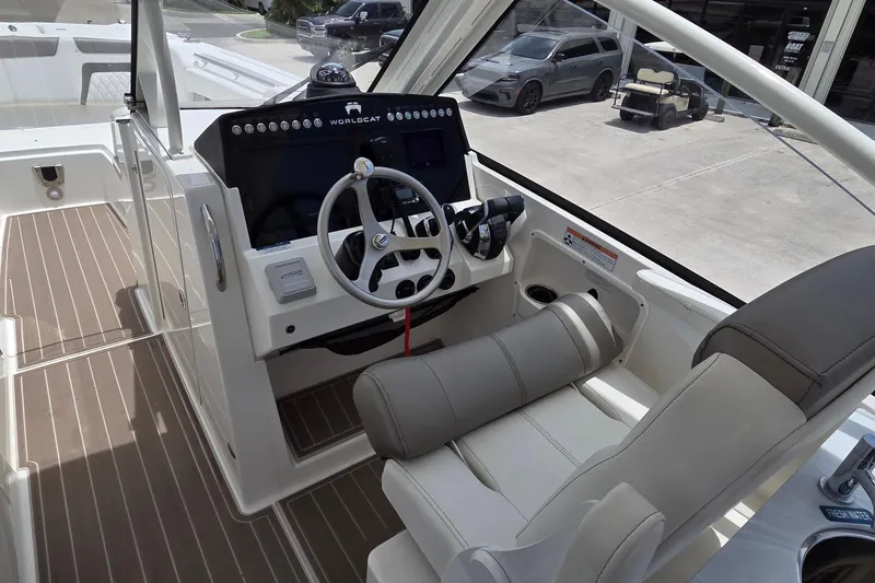 Slide: The Image of Interior view of 2023 World Cat 280 DC-X boat cockpit with steering wheel and controls. - 10
