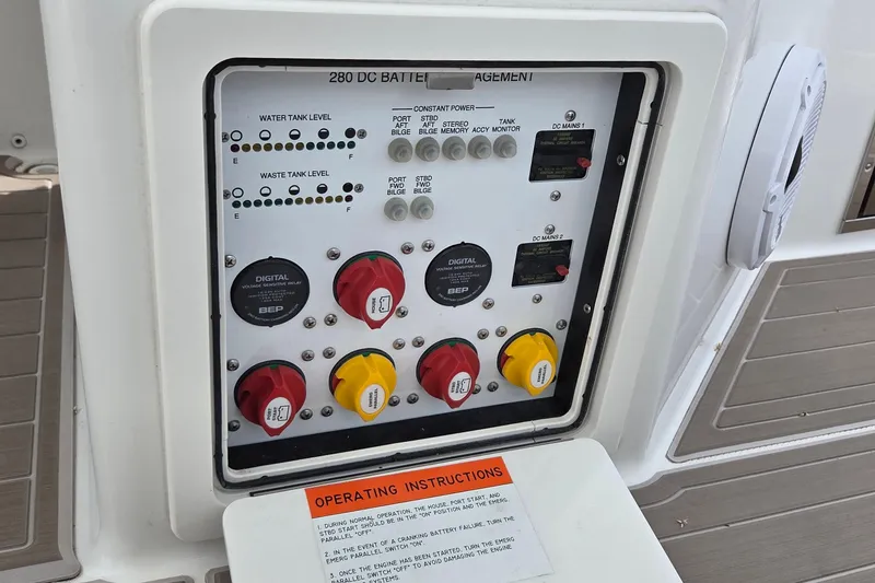 Slide: The Image of Control panel of 2023 World Cat 280 DC-X boat, featuring battery management and tank levels. - 12