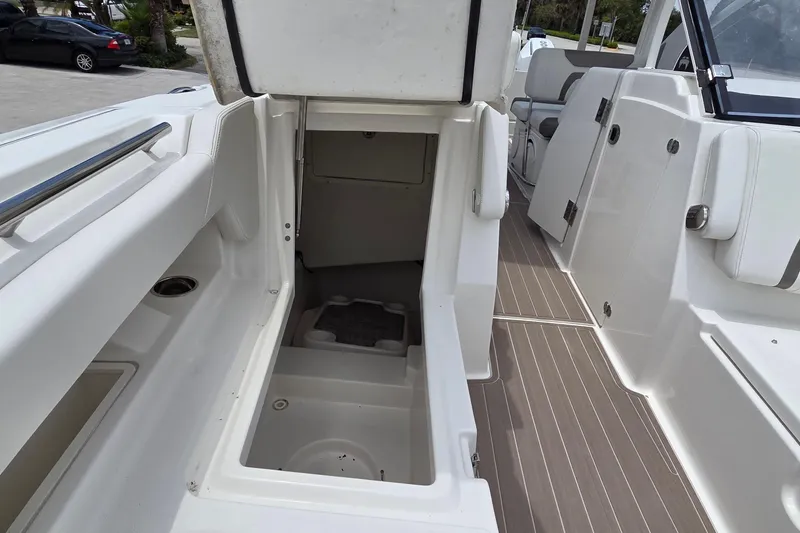 Slide: The Image of 2023 World Cat 280 DC-X boat interior with open storage compartment and seating area. - 15