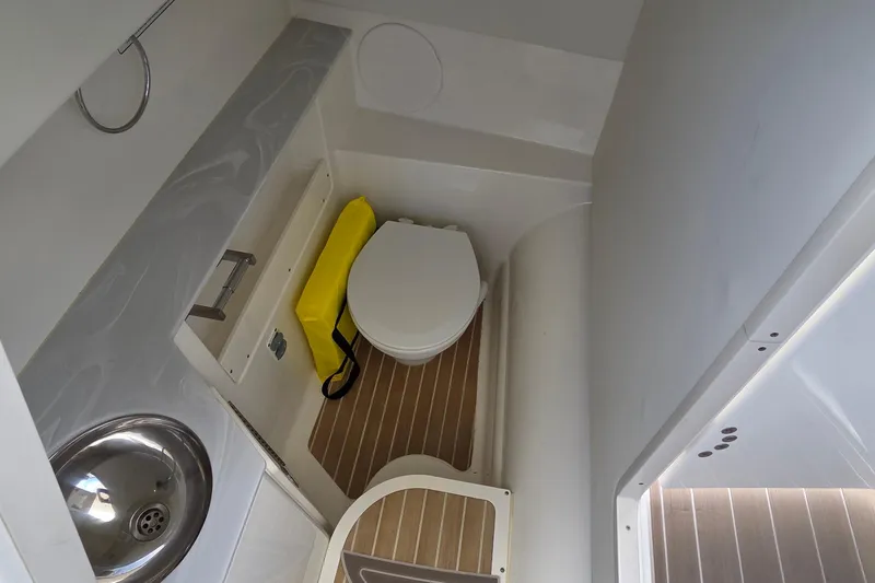 Slide: The Image of 2023 World Cat 280 DC-X boat bathroom with toilet and sink. - 20