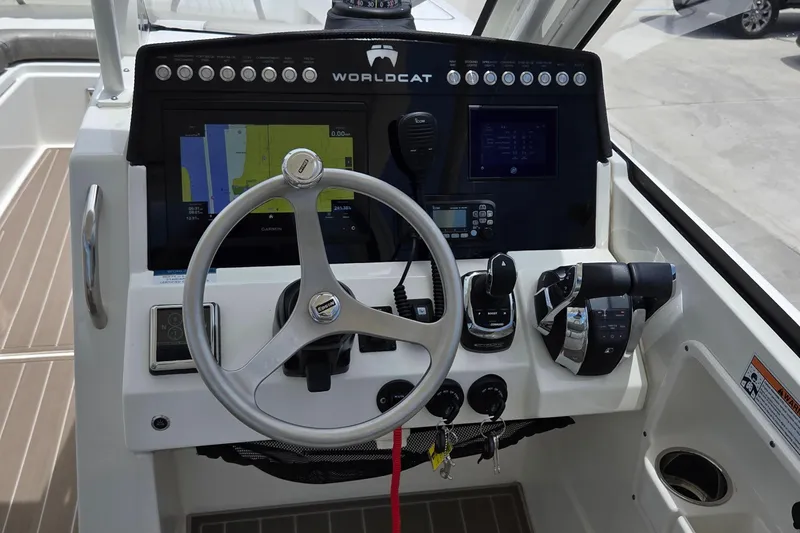 Slide: The Image of 2023 World Cat 280 DC-X helm with steering wheel, controls, and navigation display. - 23