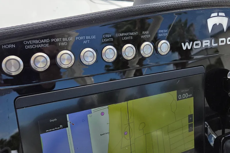 Slide: The Image of Control panel of 2023 World Cat 280 DC-X boat with navigation display and labeled buttons. - 24