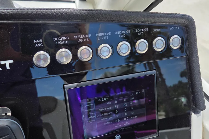 Slide: The Image of Control panel of 2023 World Cat 280 DC-X boat with various switches and display. - 25