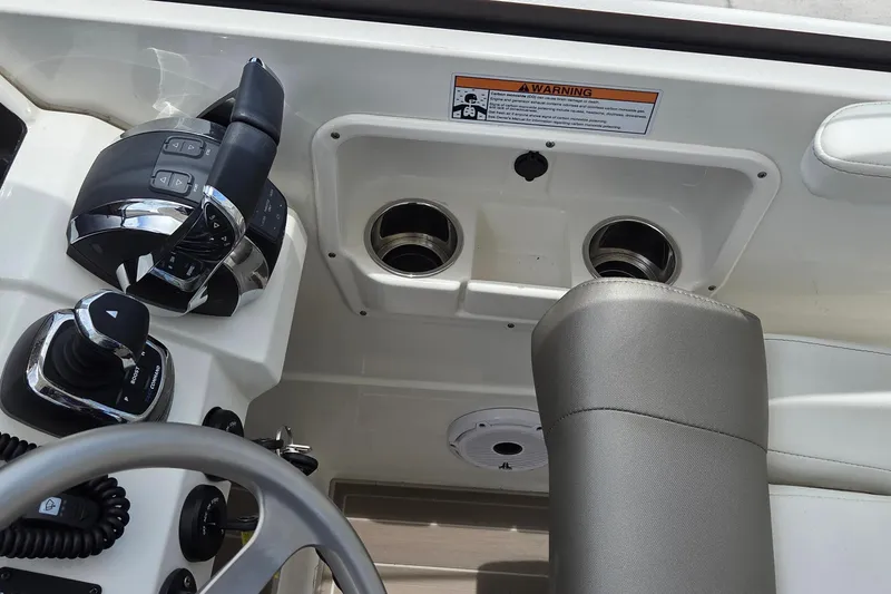 Slide: The Image of Control panel of 2023 World Cat 280 DC-X boat with steering and throttle controls. - 26