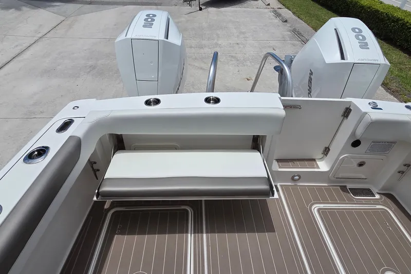 Slide: The Image of 2023 World Cat 280 DC-X boat deck with seating and twin Mercury engines. - 28