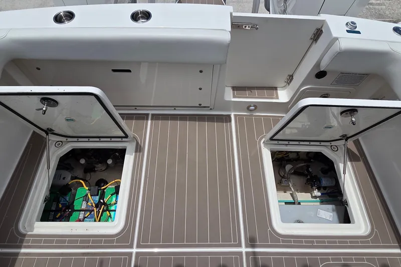 Slide: The Image of 2023 World Cat 280 DC-X boat deck with open storage compartments. - 29