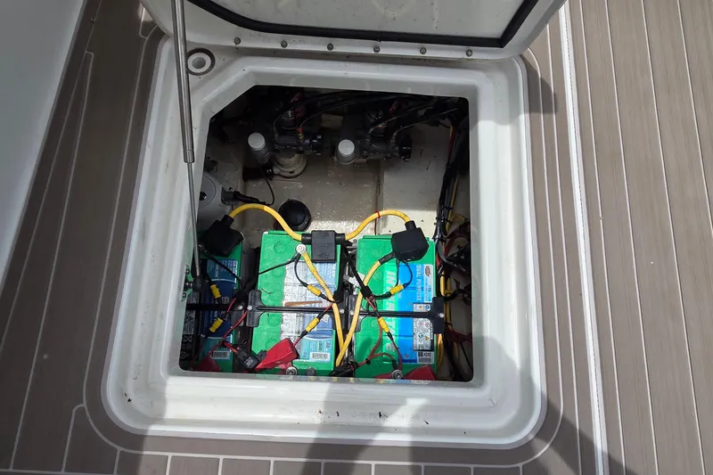 Slide: The Image of Battery compartment of 2023 World Cat 280 DC-X boat, showing wiring and connections. - 30
