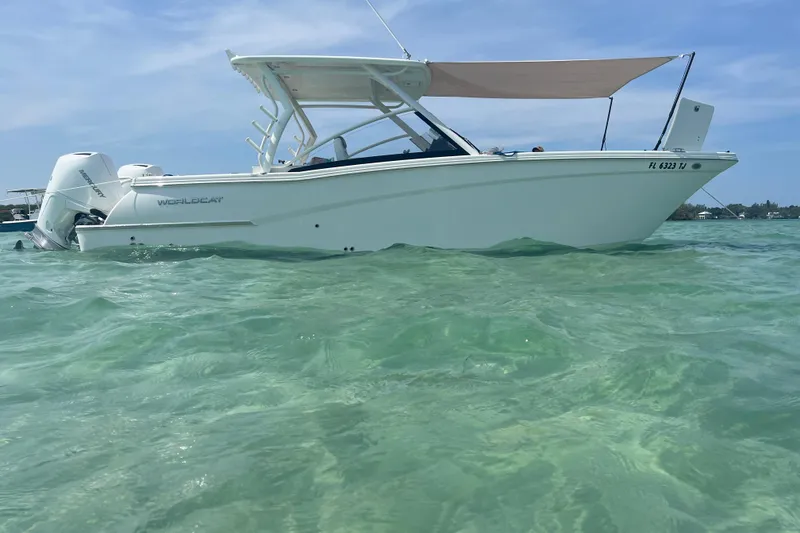 Slide: The Image of 2023 World Cat 280 DC-X boat on clear turquoise water under blue sky. - 5