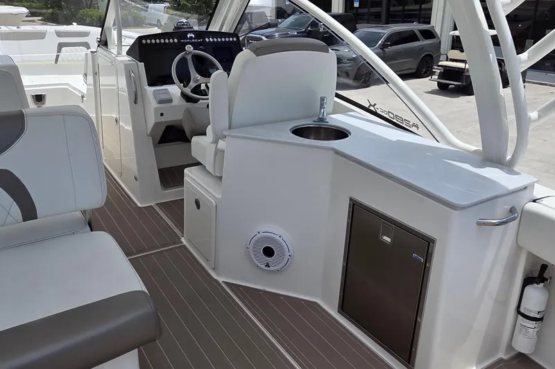 Slide: The Image of Interior of 2023 World Cat 280 DC-X boat with helm, seating, and sink area. - 9