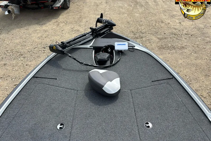 Slide: The Image of 2025 Nitro Z17 boat deck with Lowrance electronics and trolling motor on a gravel surface. - 7
