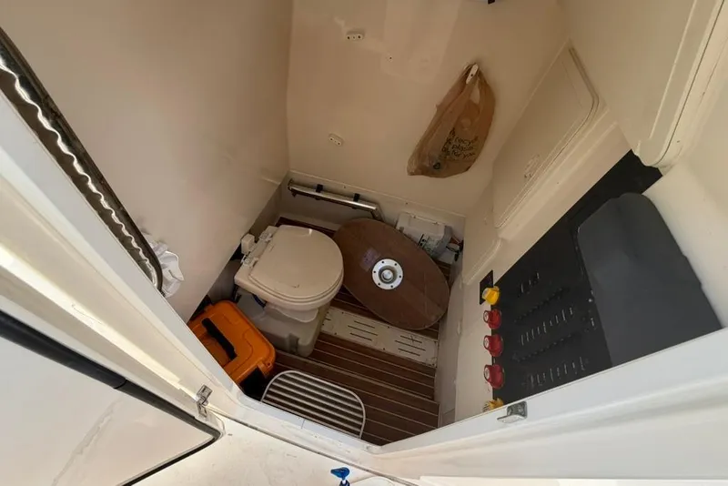 Slide: The Image of 2019 Scout 275 LXF boat interior with toilet and control panel. - 10