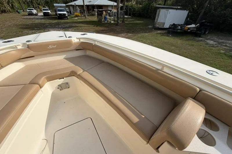 Slide: The Image of 2019 Scout 275 LXF boat interior with tan seating and spacious layout. - 13