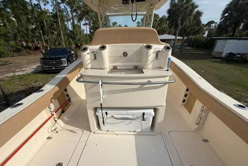 Slide: The Image of 2019 Scout 275 LXF boat interior with fishing rod holders and storage. - 7