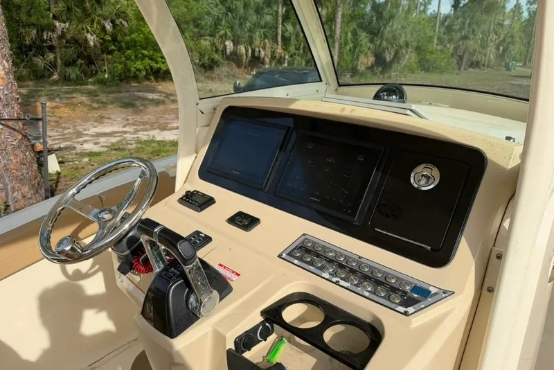 Slide: The Image of 2019 Scout 275 LXF boat dashboard with steering wheel and control panel. - 9