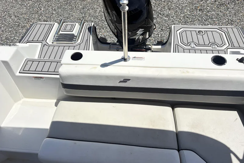 Slide: The Image of 2022 Starcraft SVX 191 OB boat interior with seating and motor, featuring cup holders. - 17