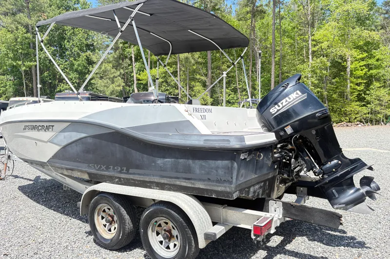 Slide: The Image of 2022 Starcraft SVX 191 OB boat with Suzuki outboard motor on a trailer. - 4