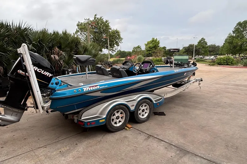 Slide: The Image of 2009 Triton 22 TrX boat on trailer, parked outdoors with Mercury outboard motor. - 10