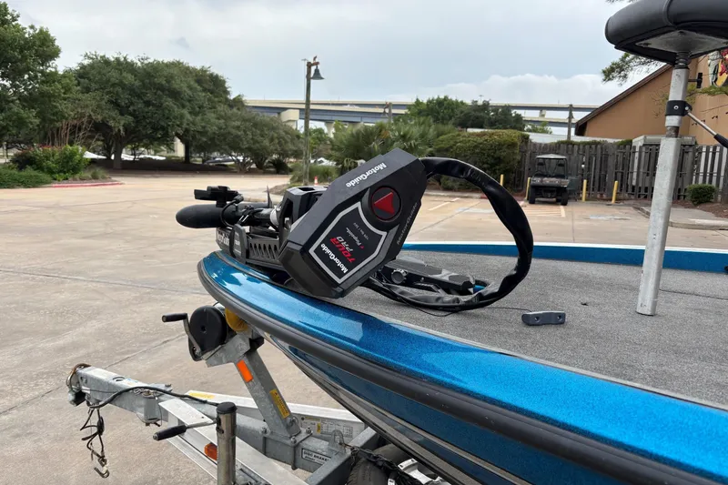 Slide: The Image of 2009 Triton 22 TrX boat on trailer with Minn Kota trolling motor in parking lot. - 3