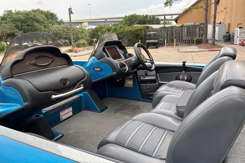 Slide: The Image of 2009 Triton 22 TrX boat interior with gray seats and dual consoles. - 4