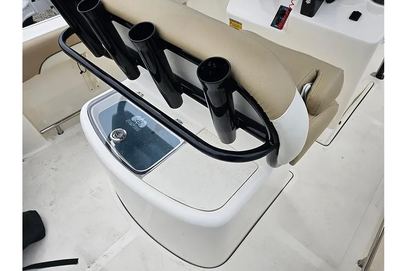 Slide: The Image of 2020 Pioneer 202 Sportfish boat interior with rod holders and cushioned seating. - 11