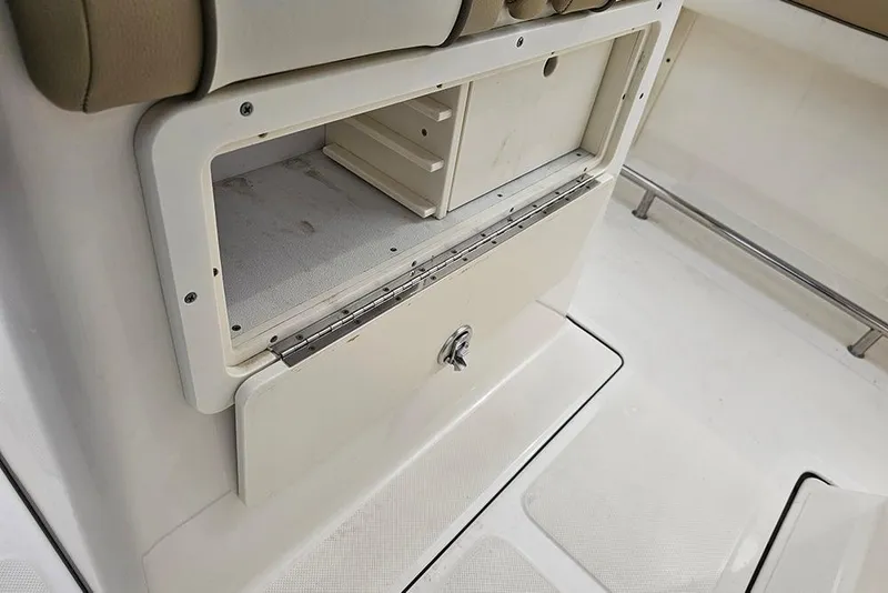 Slide: The Image of Storage compartment on a 2020 Pioneer 202 Sportfish boat, featuring a secure latch. - 15