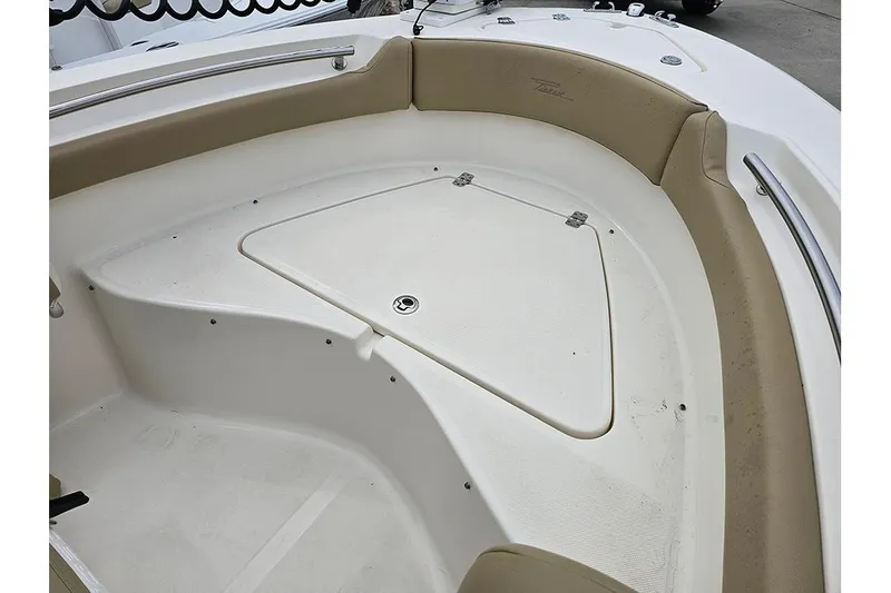 Slide: The Image of 2020 Pioneer 202 Sportfish boat interior with cushioned seating and storage compartment. - 16