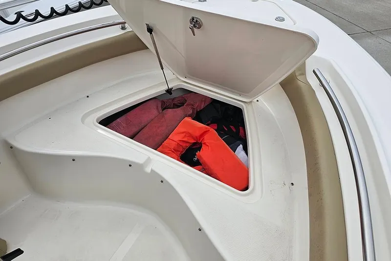 Slide: The Image of Storage compartment on a 2020 Pioneer 202 Sportfish boat, containing life jackets and gear. - 17