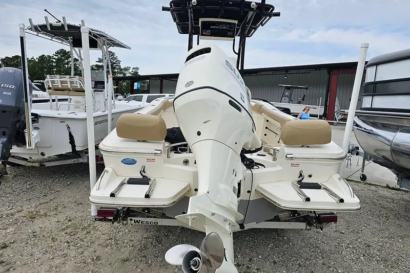 Slide: The Image of 2020 Pioneer 202 Sportfish boat, rear view, showcasing outboard motor and seating. - 7