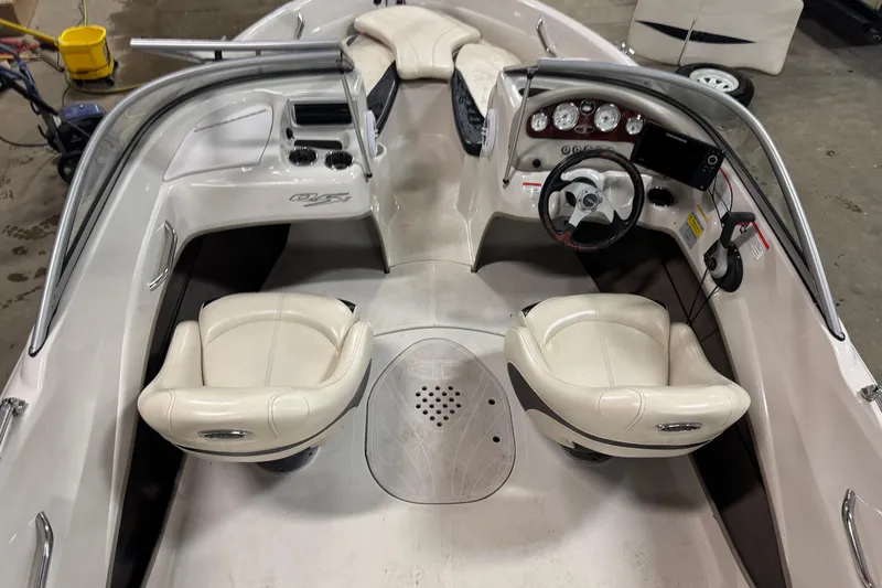 Slide: The Image of Interior of a 2013 Tahoe Q5i boat with steering wheel and seating. - 11