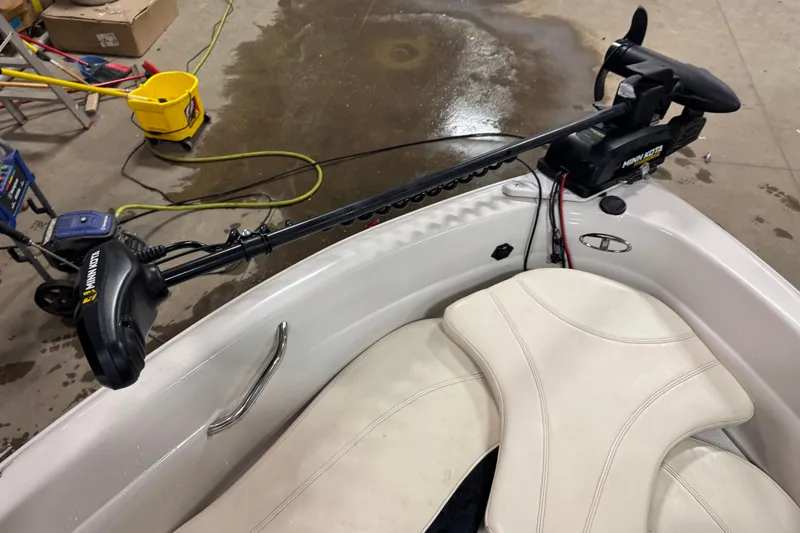 Slide: The Image of 2013 Tahoe Q5i boat with Minn Kota trolling motor in a garage setting. - 13